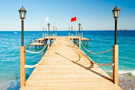 light poles and rope fence on wooden pierの写真素材