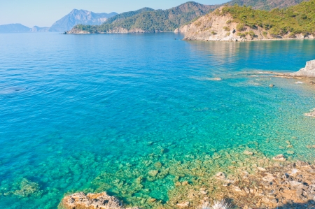 clear turquoise water and rocky shoreの写真素材
