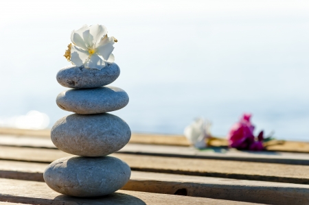 beautiful stones and flowers on a wooden pier の写真素材