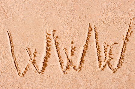 WWW written on wet sand at the seaの写真素材