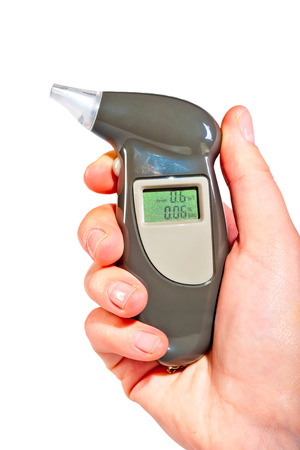 Breathalyzer in a female hand showing drunkennessの写真素材