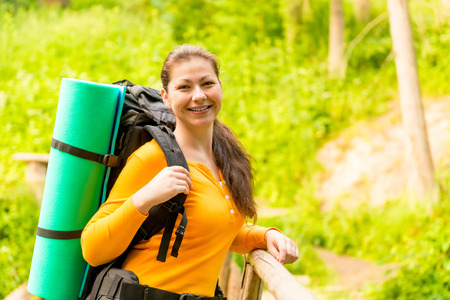 charming brunette in a hike with a backpack