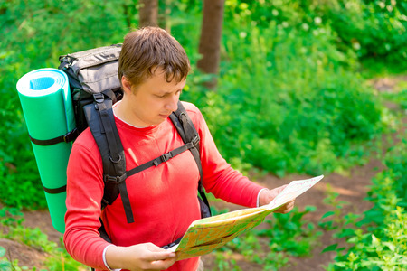 tourist is looking for its location on the map
