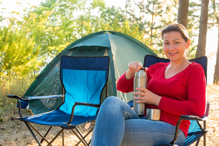 girl with a thermos of tea with a beautiful smileの写真素材