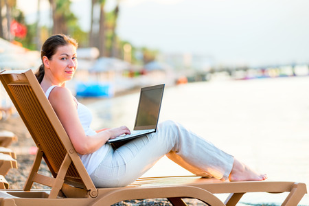 beautiful girl with a laptop in the early morningの写真素材