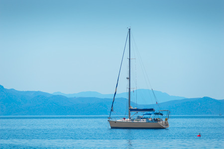 lone sailing yacht drifting in the sea
