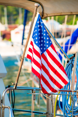 USA flag close-up set on a yacht in the portの写真素材
