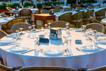 round outdoor tables covered for guestsの写真素材