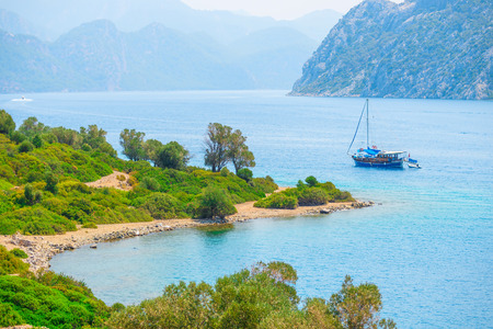 sailing yacht in the beautiful sea bay in the mountainsの写真素材