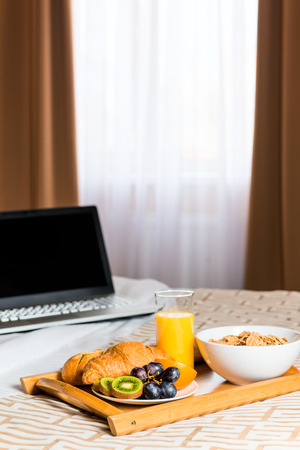 a tray of food on the bed against the windowの写真素材