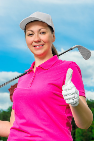 Girl portrait satisfied game of golf against the skyの写真素材