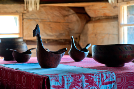 carved wooden dishes on a table in rural houseの写真素材