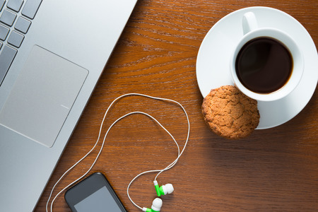 laptop and coffee cup top view on the desktopの写真素材