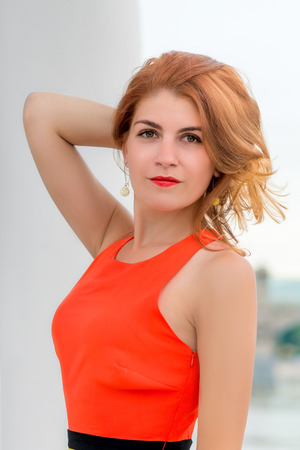 portrait of a beautiful woman in a bright dressの写真素材