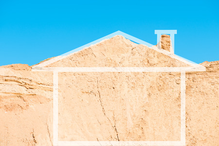 Conceptual image of the house. Mountain sandy area in the form of homeの写真素材