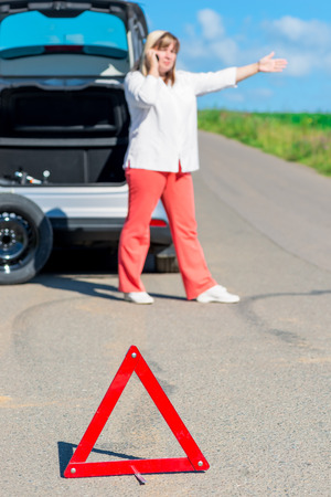 breaking on the road. Woman calling mechanic for helpの写真素材