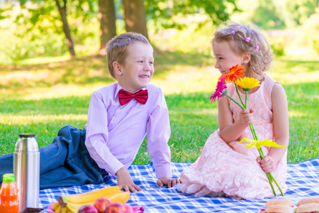 a pair of lovers of children at the picnic on the lawnの写真素材