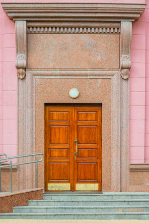 entrance to the building with wooden door vertical shotの写真素材