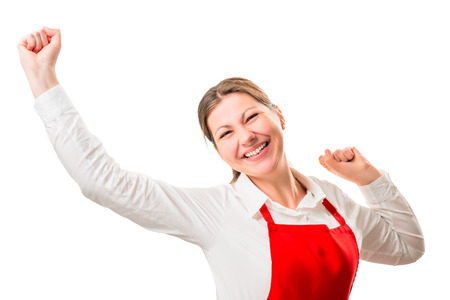 joyful pretty woman in a red apron on a white background rejoicesの写真素材