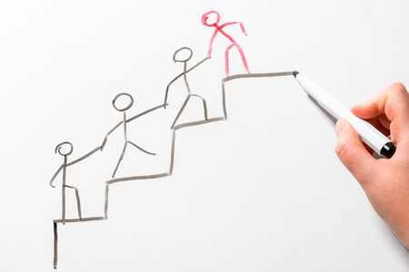 concept drawing on the blackboard - helping a colleague to move up the career ladderの写真素材