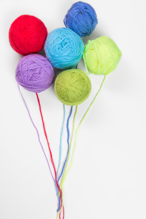 colored woolen a thread on a white background in the form of balloonsの写真素材