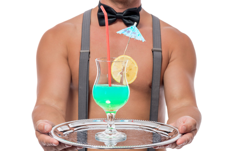 a cocktail glass on a tray in the hands of of the waiter closeupの写真素材