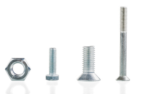 three bolts and a washer in a row isolated on white backgroundの写真素材