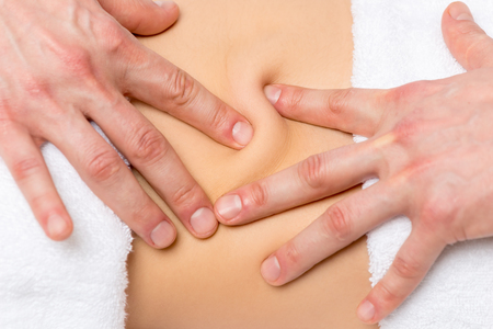 the fingers masseur and the skin of the back close-upの写真素材