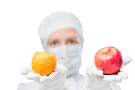 Biologist shows the result of the impact of toxic substances on the appleの写真素材