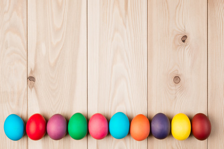 a series Easter eggs and a wooden background for an inscriptionの写真素材