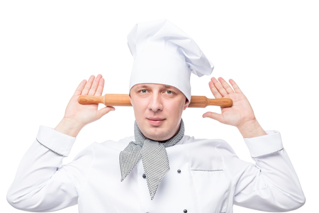 humorous chef with a wooden rolling pin on a white backgroundの写真素材