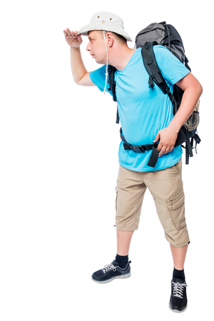 Man with a backpack in full length looking into the distance on a white backgroundの写真素材