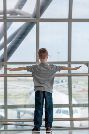 Boy flies with a plane at the airport, children's dreamsの写真素材