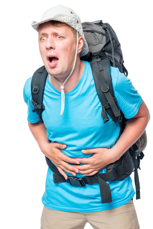 Tourist with diarrhea experiencing abdominal pain in a hike against a white backgroundの写真素材