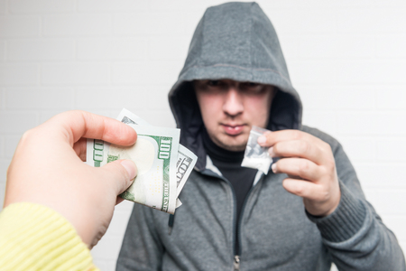 The buyer and the drug dealer carry out the transaction