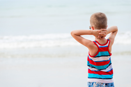 Boy on vacation at sea, relaxed looking at the seaの写真素材