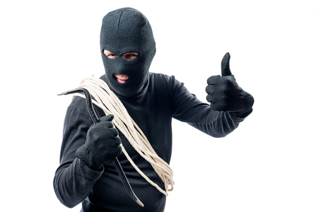 Burglar with rope on white background in studioの写真素材