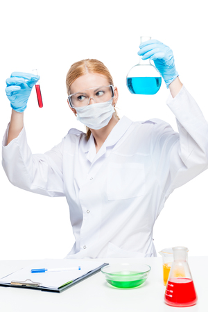Woman chemist lab assistant with test tubes doing substance analysisの写真素材
