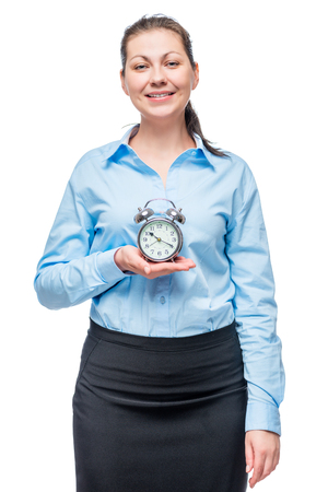 Successful businesswoman with an alarm clock in hands on a white backgroundの写真素材