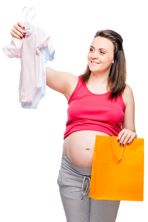 happy pregnant lady chooses body for a boy or girl on a white backgroundの写真素材