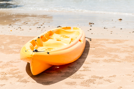 a kayak for active sports on the water lies on a sandy beachの写真素材