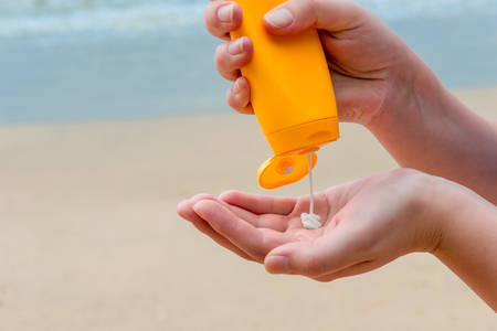 close-up of women's hands with sunscreen