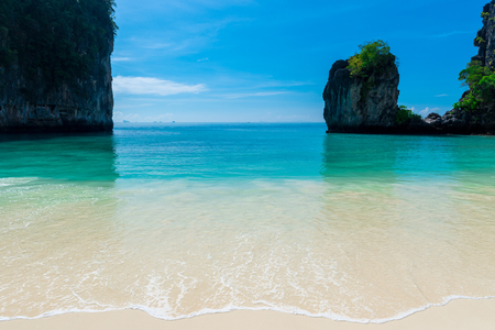 sea wave of a calm turquoise sea on a white sand beach in Thailandの写真素材