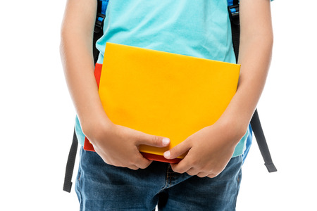 closeup of a schoolboy holding books, shooting on a white background in the studioの写真素材