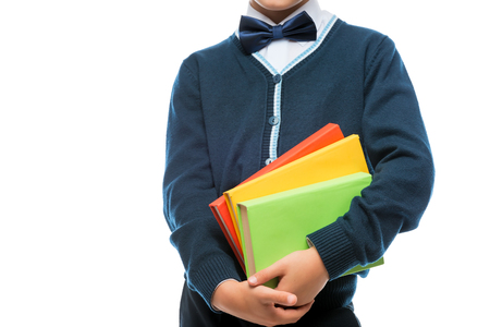 schoolboy in uniform with books on white backgroundの写真素材