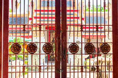 closed steel gates - entrance to the temple of Bangkokの写真素材