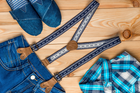 set of clothes in a rural style top view on a wooden floor for a boyの写真素材