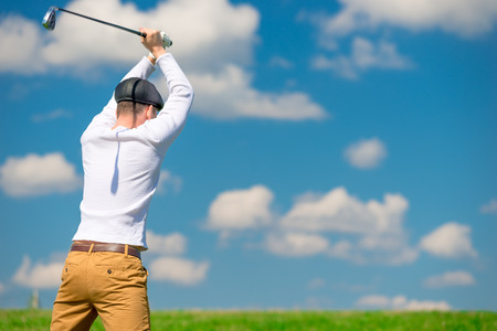 an evil aggressive golfer breaks his golf club after losing the gameの写真素材