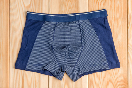 blue new cotton panties for boy clothes on wooden boards top viewの写真素材