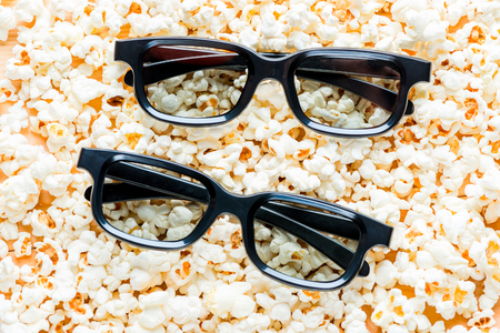 two pairs of 3d glasses close-up lie on salted popcornの写真素材